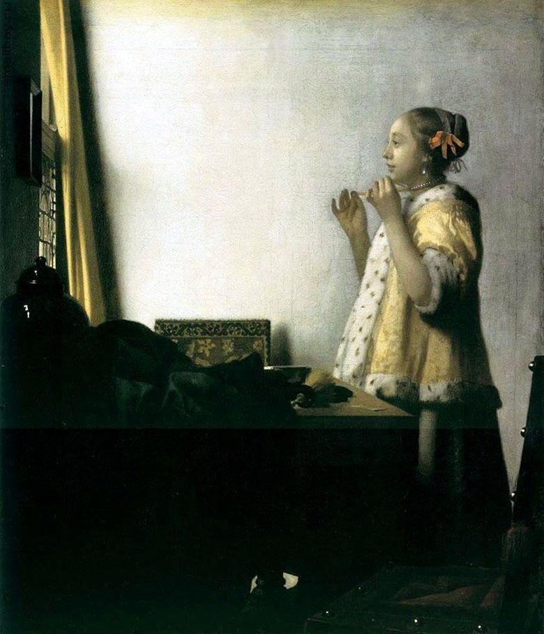 Flicka som försöker på ett halsband   Jan Vermeer